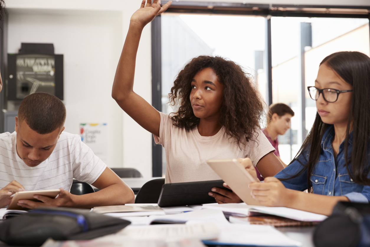 female high school student raising hand