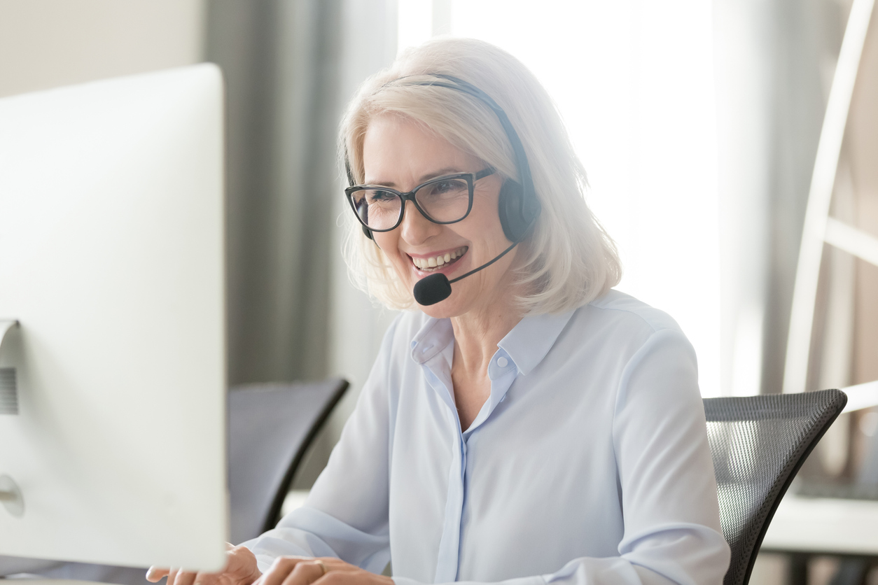 woman on computer with headphones on